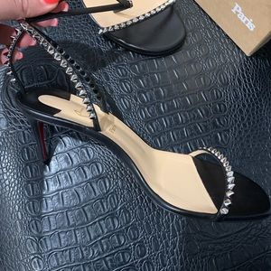 Louboutin strappy spike sandal heel.